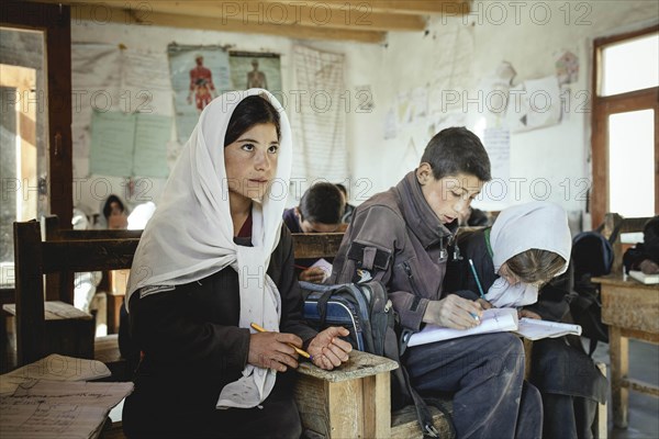 Three pupils in a school desk