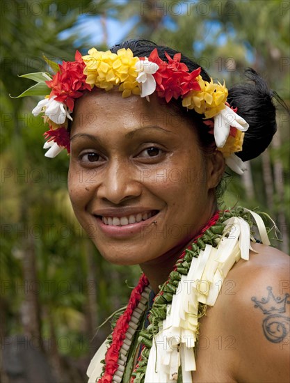 Young smiling local woman with traditional flower decoration