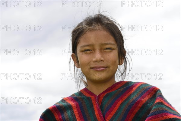 Indigenous girl looks smiling into the camera