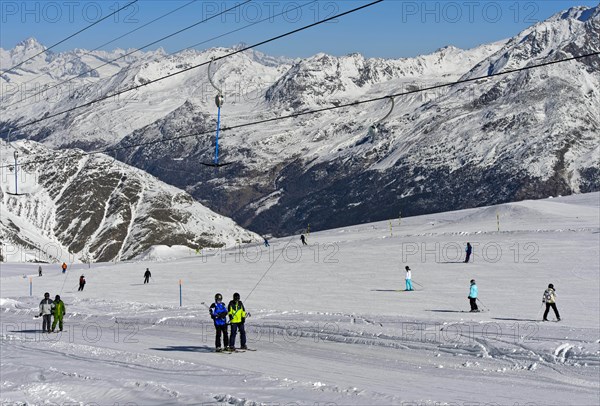 Skiers on the ski slope on the Fee glacier