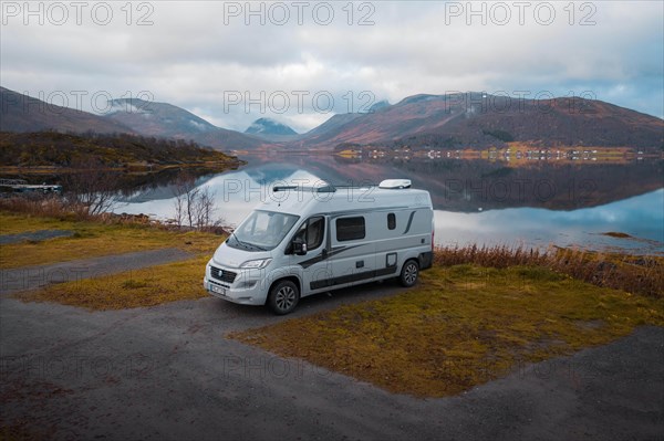 Campervan parked in the parking lot at Fjordbotn Camping