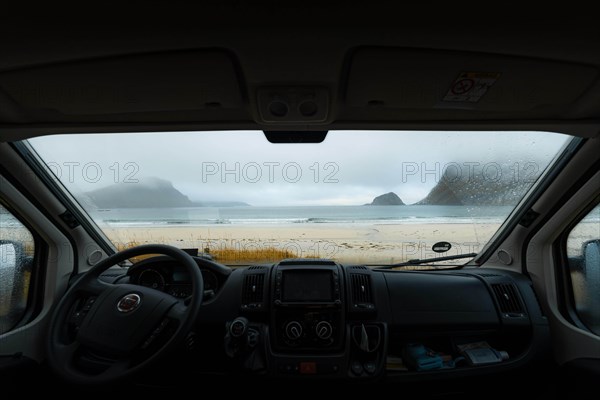 View from the windshield of the campervan on beach with turquoise water