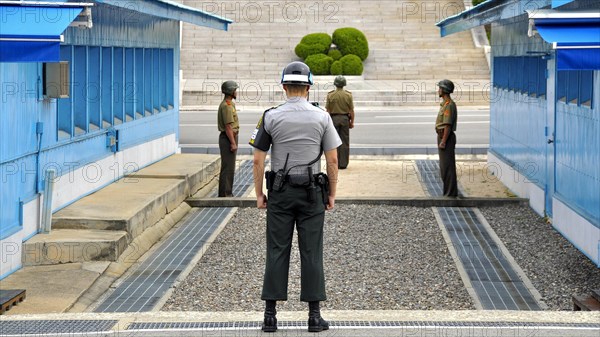 Soldiers standing at the blue barracks in the demilitarized zone