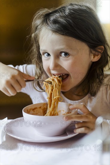 Girl eating spaghetti