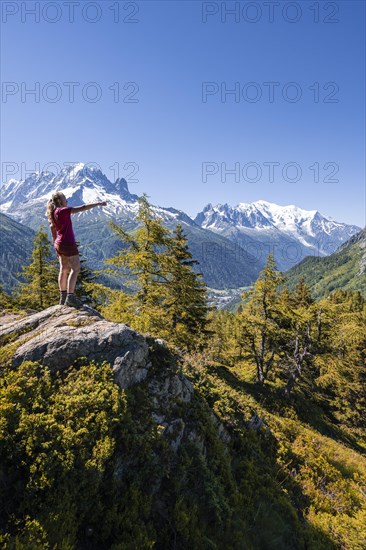 Hiker pointing at mountain panorama