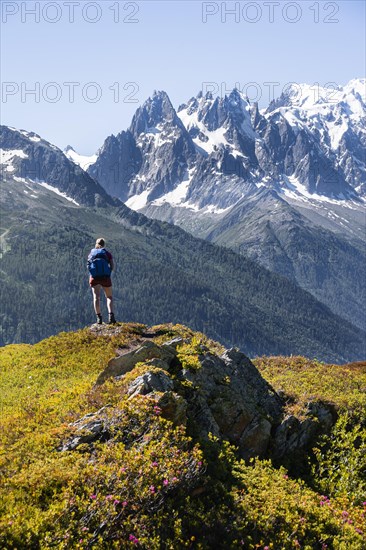Hiker looking at mountain panorama from Aiguillette des Posettes