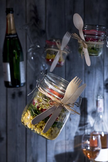 Food in glasses with wooden cutlery