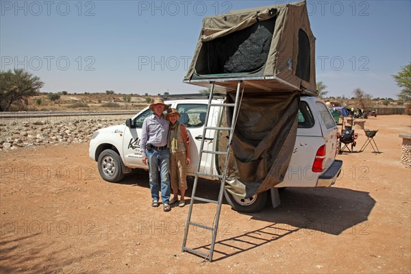 Four-wheel drive car with roof tent at the campsite