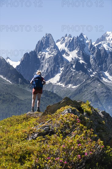 Hiker looking at mountain panorama from Aiguillette des Posettes