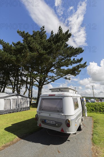 Caravan with elevating roof on a pitch