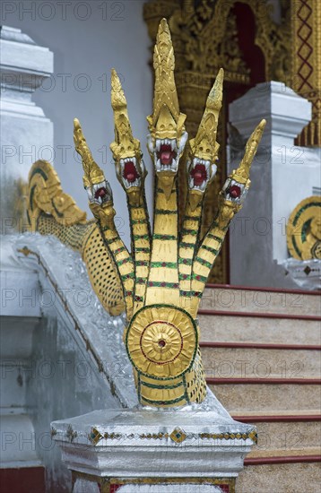 Five-headed mythological Naga serpent decorates the end of a stair railing