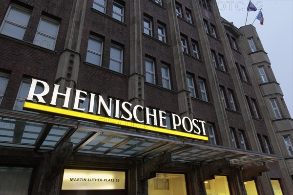 Illuminated logo of the daily newspaper Rheinische Post on the former editorial building Martin-Luther-Platz