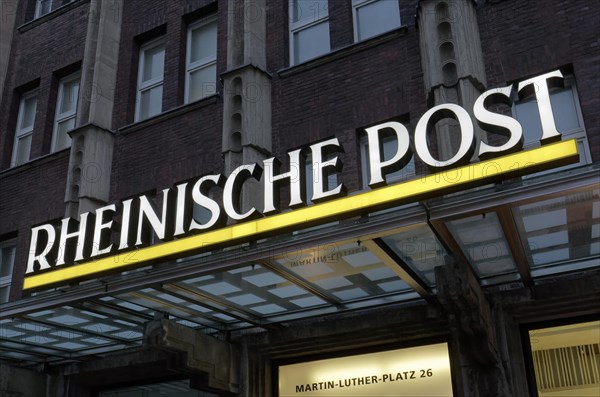 Illuminated logo of the daily newspaper Rheinische Post on the former editorial building Martin-Luther-Platz