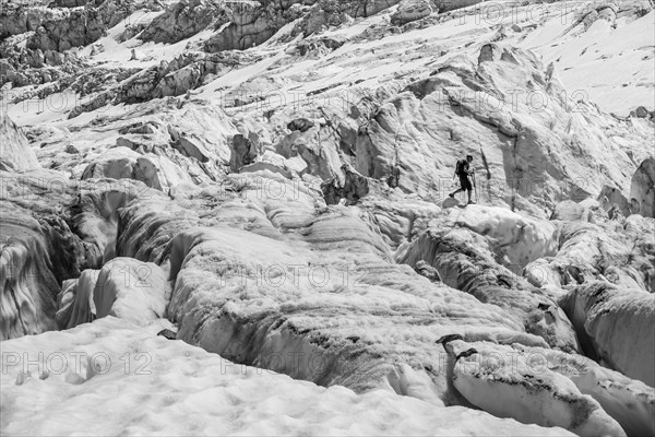 Climber walking on rutted glacier