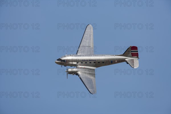 Douglas DC-3 Dakota aircraft in flight in Norway markings