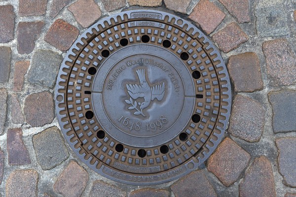 Manhole cover with the symbol of a peace dove on the occasion of the 350th anniversary of the Peace of Westphalia