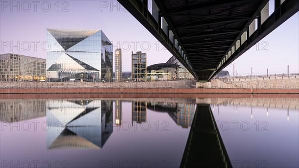 Reflection on the Spree at the main station with bridge and cube