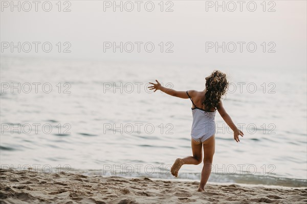Happy girl on sandy beach