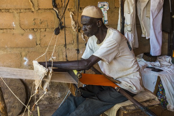 Man waiving on a traditional loom