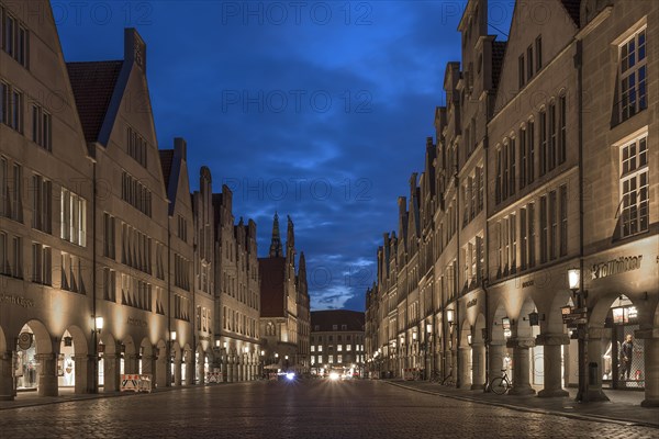 Illuminated historic gabled houses in the evening at blue hour