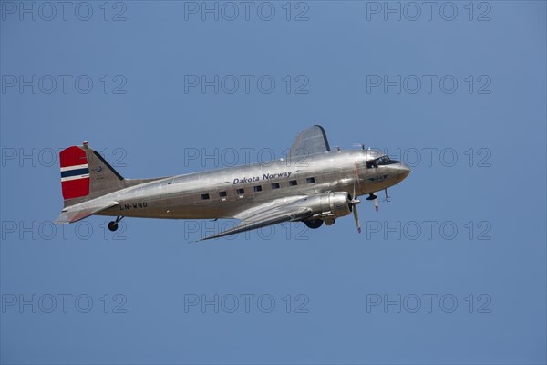 Douglas DC-3 Dakota aircraft in flight in Norway markings