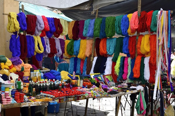 Stall with colorful wool at the weekly market market