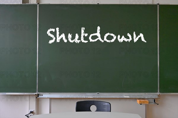 Blackboard with inscription SHUTDOWN