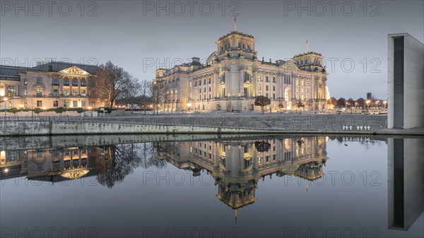 Reichstag with waving German flag at the Spree