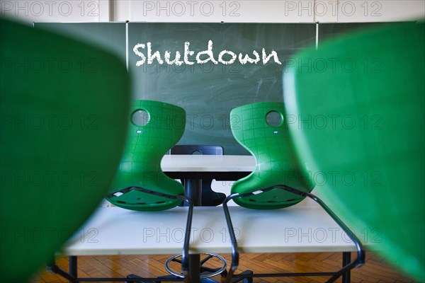 Blackboard with inscription SHUTDOWN