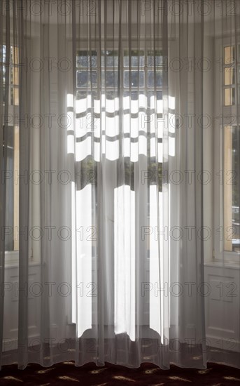 Light falls through curtain