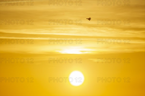 Eurofighter Typhoon aircraft in flight of the Royal air force at sunset