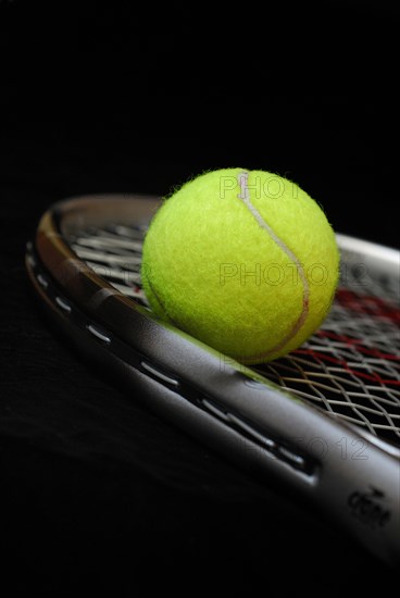 Tennis ball on racket