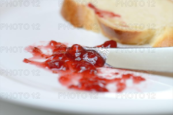 Jam and slice of braided butter