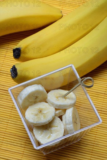 Banana slices in peel and bananas