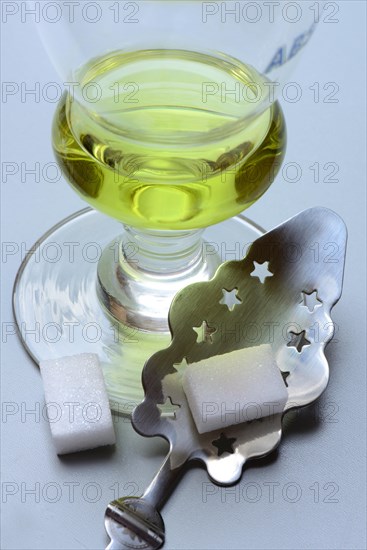 Glass of absinthe with absinthe spoon and sugar cubes