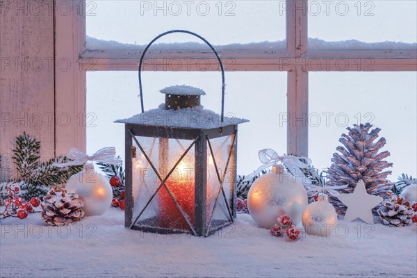 Lantern with Christmas decoration on windowsill