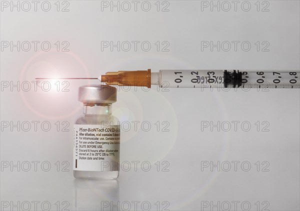 Vaccine vial against Covid 19 and syringe with drops