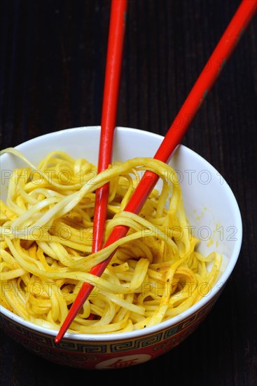 Chinese noodles in bowl with chopsticks