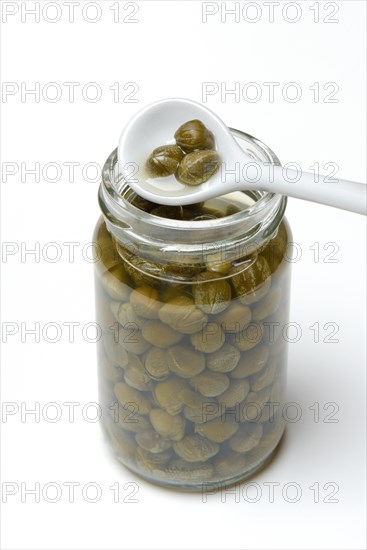 Glass and porcelain spoon with capers