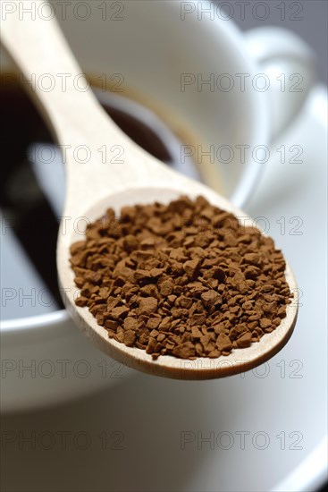 Instant coffee with wooden spoon and coffee cup