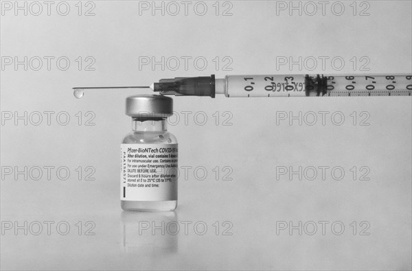 Vaccine vial against Covid 19 and syringe with drops