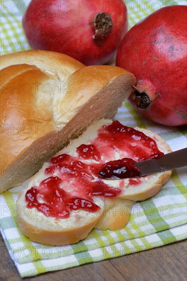 Pomegranate jelly on a slice of butter plait