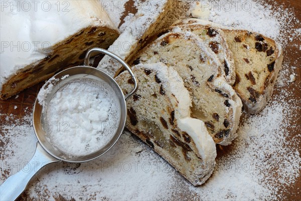 Christmas stollen and sieve with icing sugar