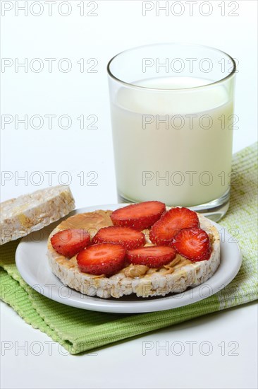 Corn and rice waffle topped with strawberries and peanut butter