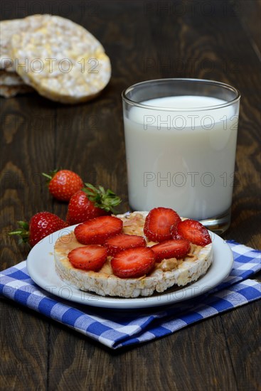 Corn and rice waffle topped with strawberries and peanut butter