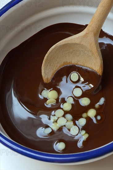 Liquid chocolate coating and melting cocoa butter with spoon