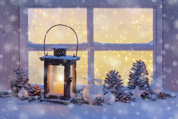 Lantern with Christmas decoration on windowsill