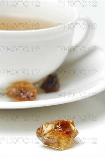 Cup of tea and brown rock candy