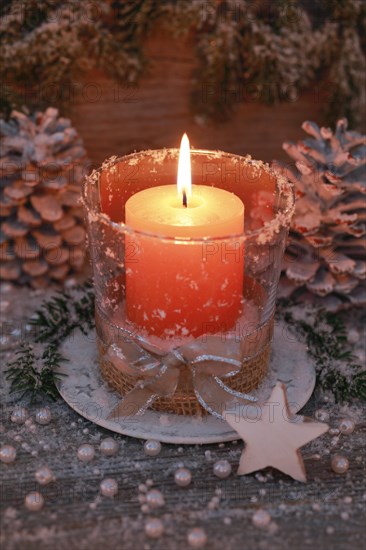Natural advent decoration with burning candle