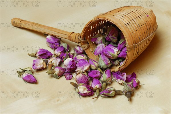 Dried rosebuds in bamboo tea strainer